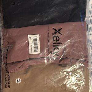 Xelky Black, Mauve, and Tan bodysuits